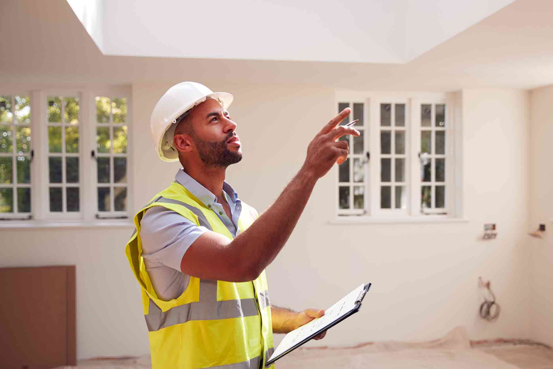 Third Party Wall Surveyors Leicester reviewing plans between two parties during a dispute